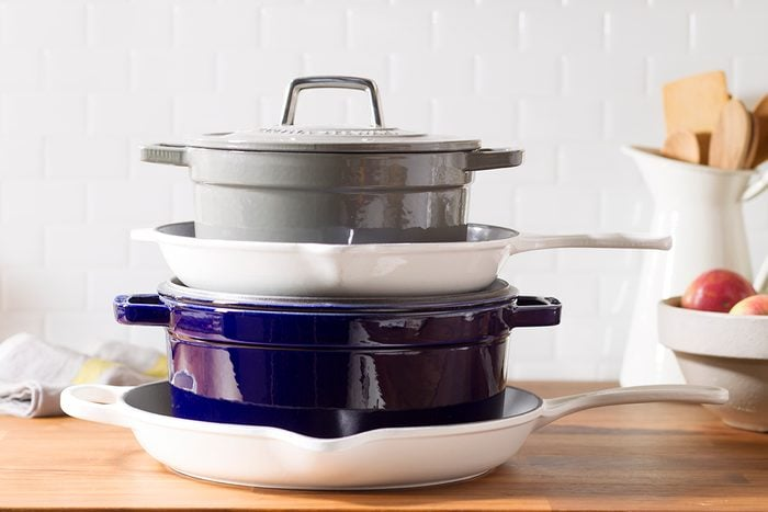 Dutch ovens stacked over one another. 