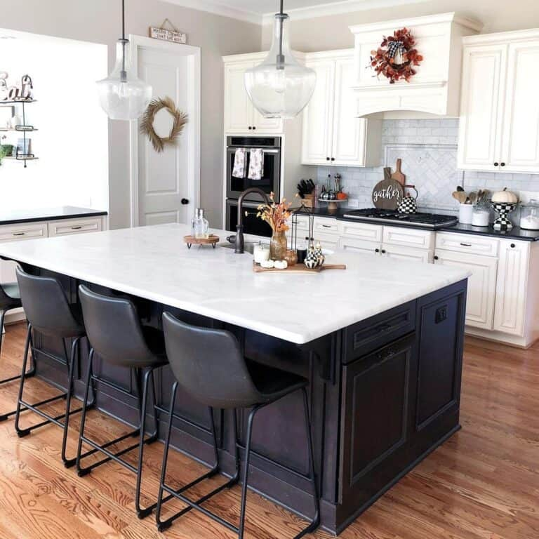 Black and white kitchen island with black stools