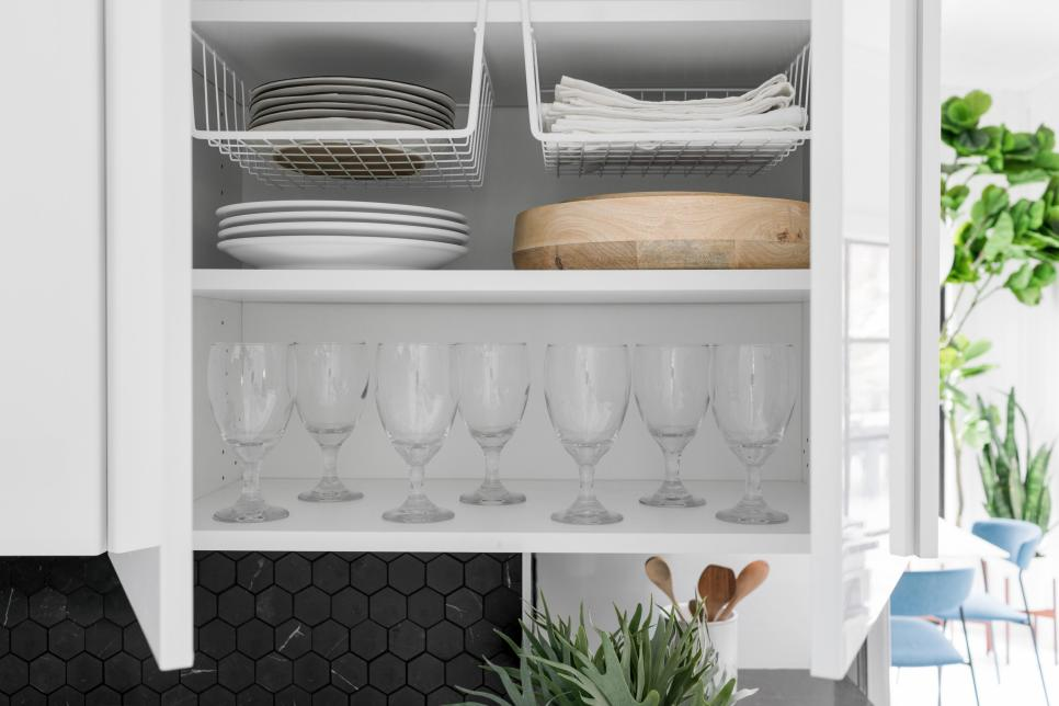 glasses and dishes organized in a kitchen cabinet