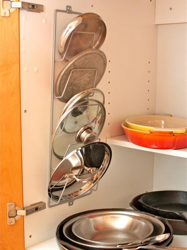 pot lids hanged on a kitchen cabinet door