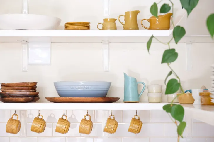 hanging mugs under a kitchen shelf