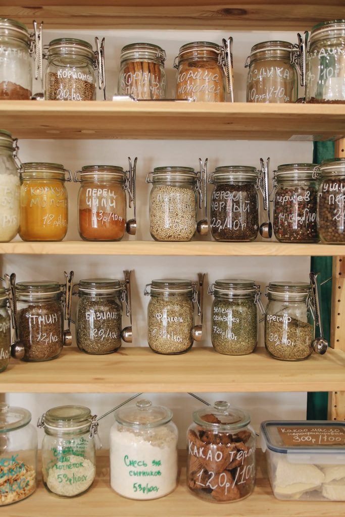 Clear Glass Jars on White Wooden pantry Shelf