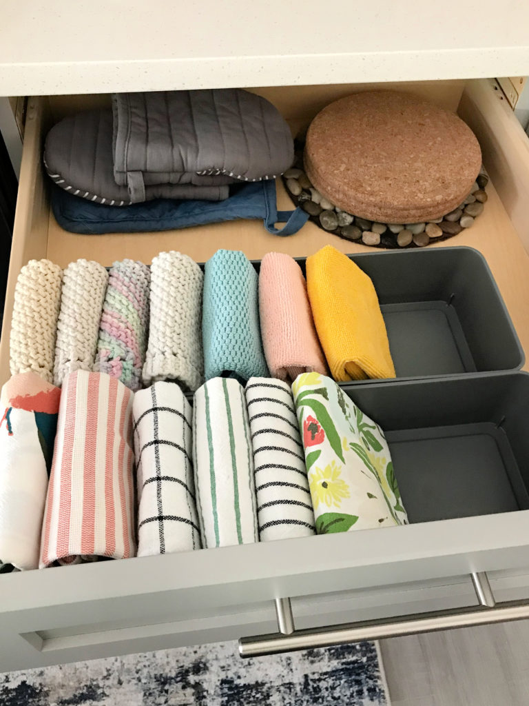 An organized kitchen drawer for kitchen towels and dish cloths
