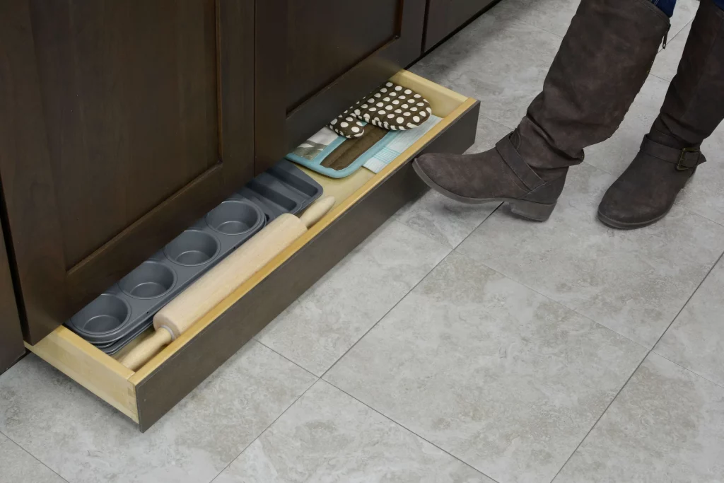 toe-space drawer for storing cutting boards and trays